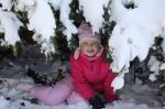 Daughter under snow-covered yew