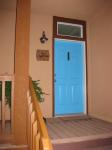 Blue front door in Southwest style.