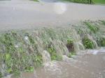 water running across the road into a ditch thats abot 3' deep.