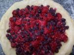 Making raspberry blueberry pie