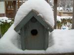 snow covered birdhouse
