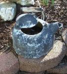 cast iron tea kettle in need of new paint job.