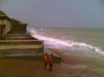 Waves striking the beach huts.