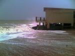 Another hut getting pounded by waves.