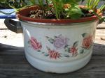 Old pot with roses painted on it